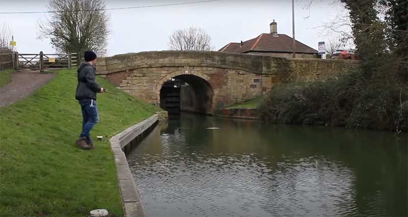 lure-fishing-for-pike-by-a-canal-bridge